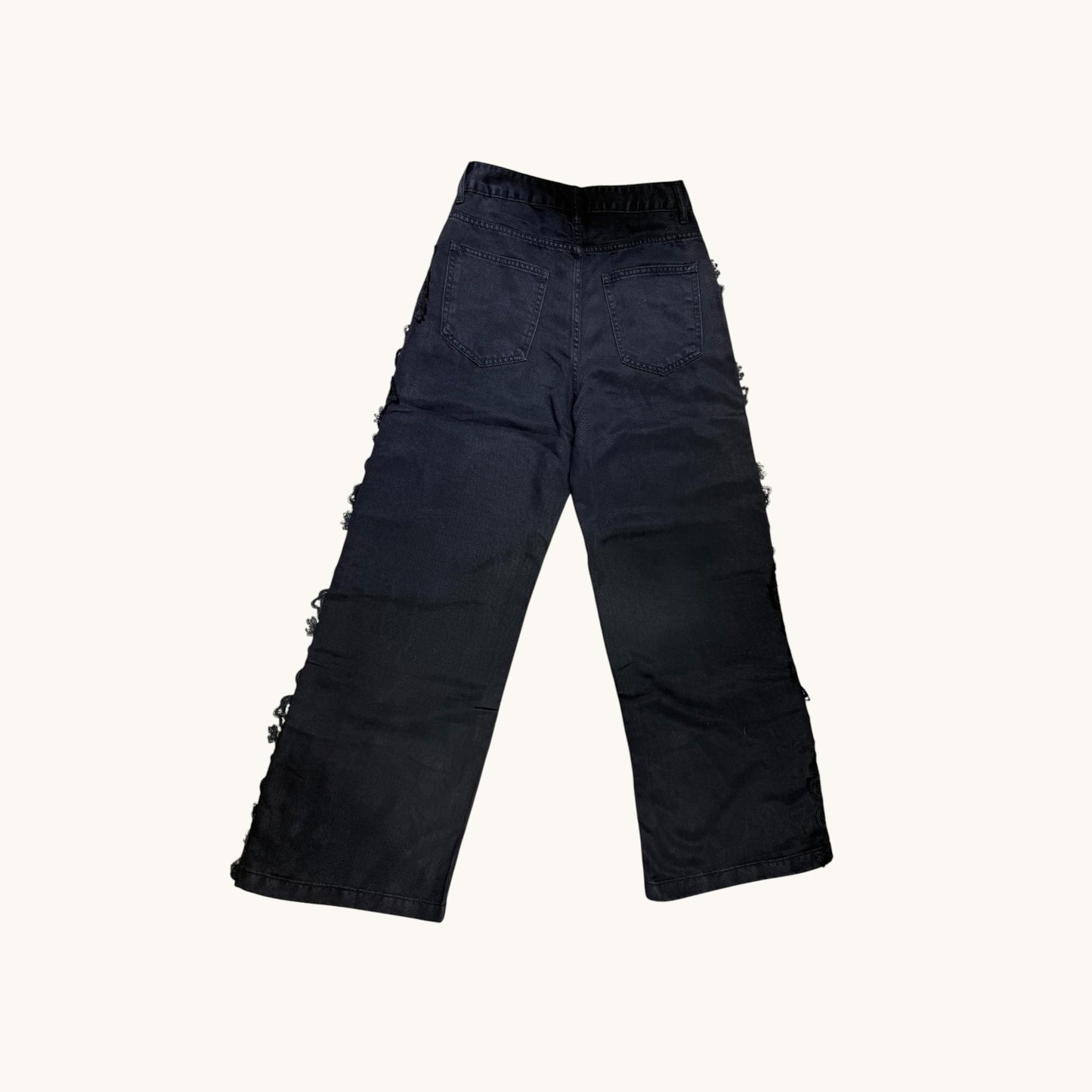 Pantalones con detalle floreado al lateral